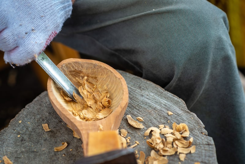 Hand-carving a beechwood spoon